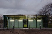 glass-cladded textile-concrete pavillon: Western view at dusk