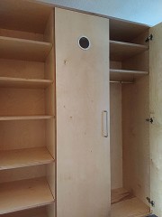 The wardrobe has three shelves with two compartments above the clothes rail