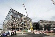 By a truck-mounted crane the facade-elements are placed at the construction site in Brugg/Windisch