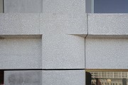 The high-rise building includes a partially sand-blasted precast façade whose vertical pilaster strips are rounded